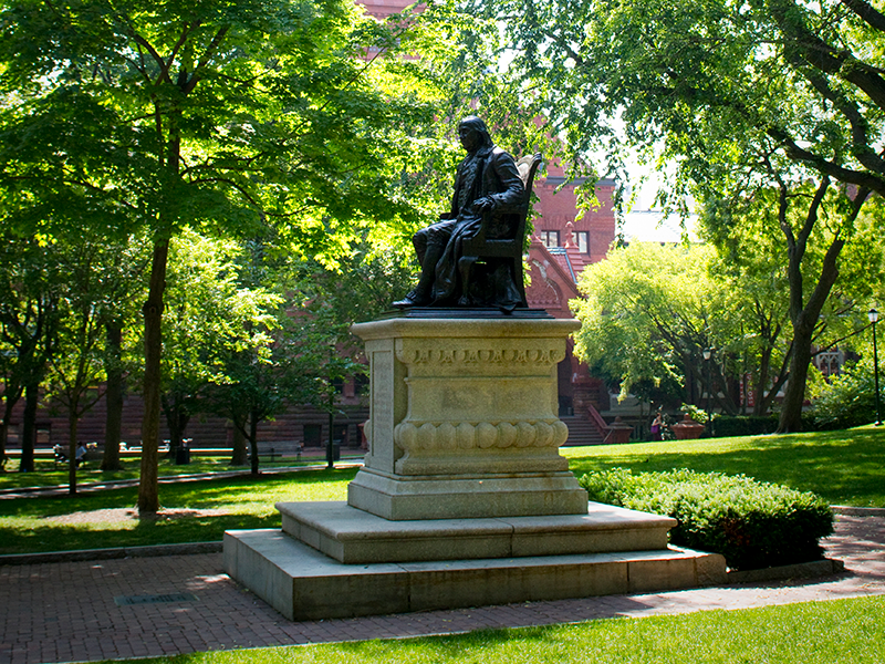 monument of ben franklin seated on bench
