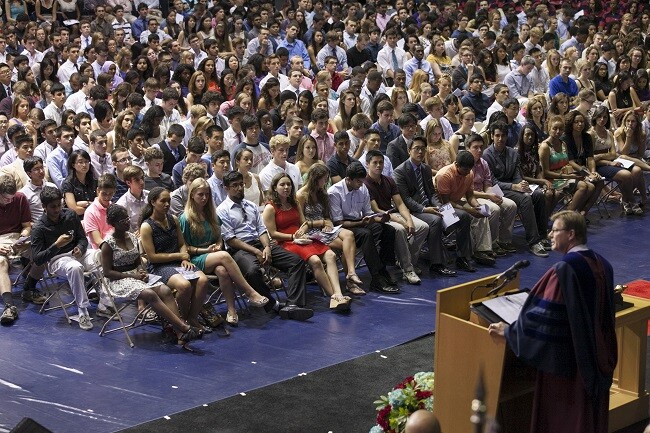 seated students listening to speaker during Convocation 2013